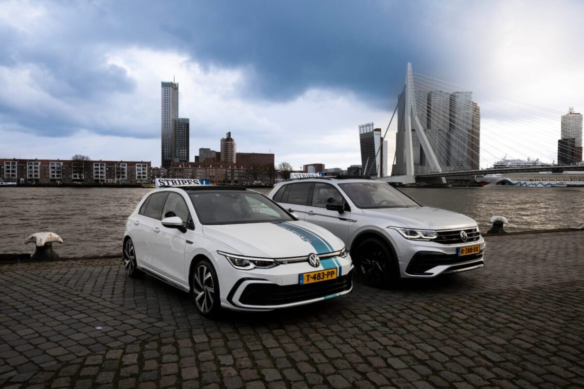 De twee lesauto's van Rijschool Stripes, automaat en schakel, aan het water in Rotterdam